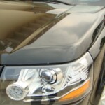 Before and after photographs of a damaged, black, Range Rover that was repaired by Elite Paint & Body Shop in West Palm Beach, FL.